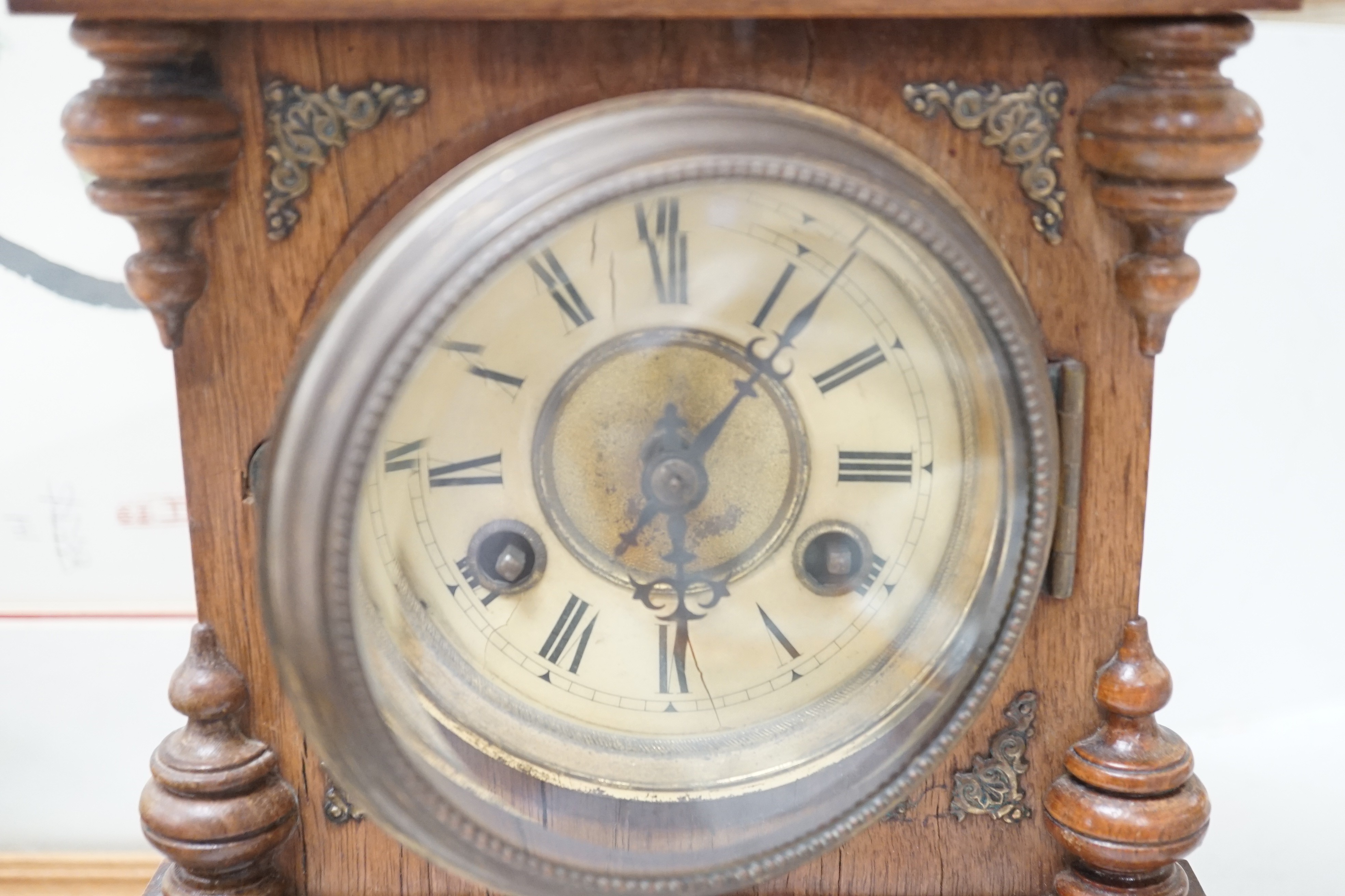 A German Black Forest mantel clock with pendulum 34.5cm
